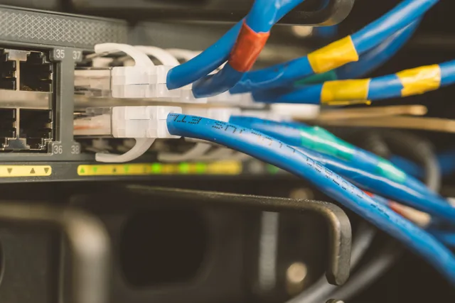 Network switch and blue ethernet cable with white tips connected to system for maintenance. Incident Response Comparison: Six Mid-Incident Forks